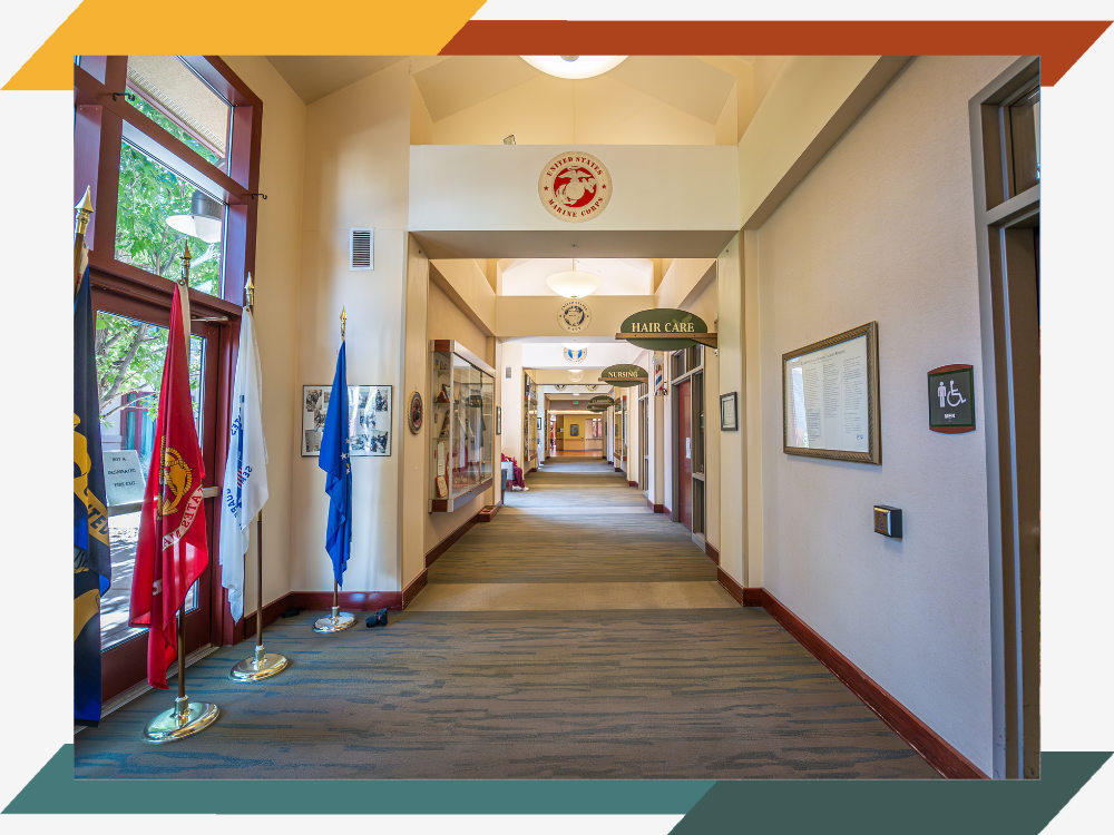 A long hallway with military insignias on the walls.