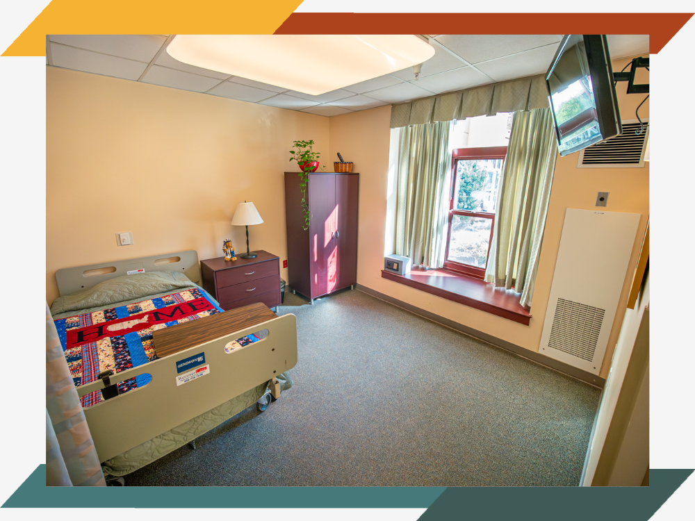 A room belonging to one of the residents. The quilt on the bed says "home".