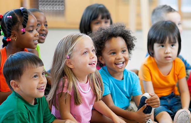 Children sitting and smiling in a classroom