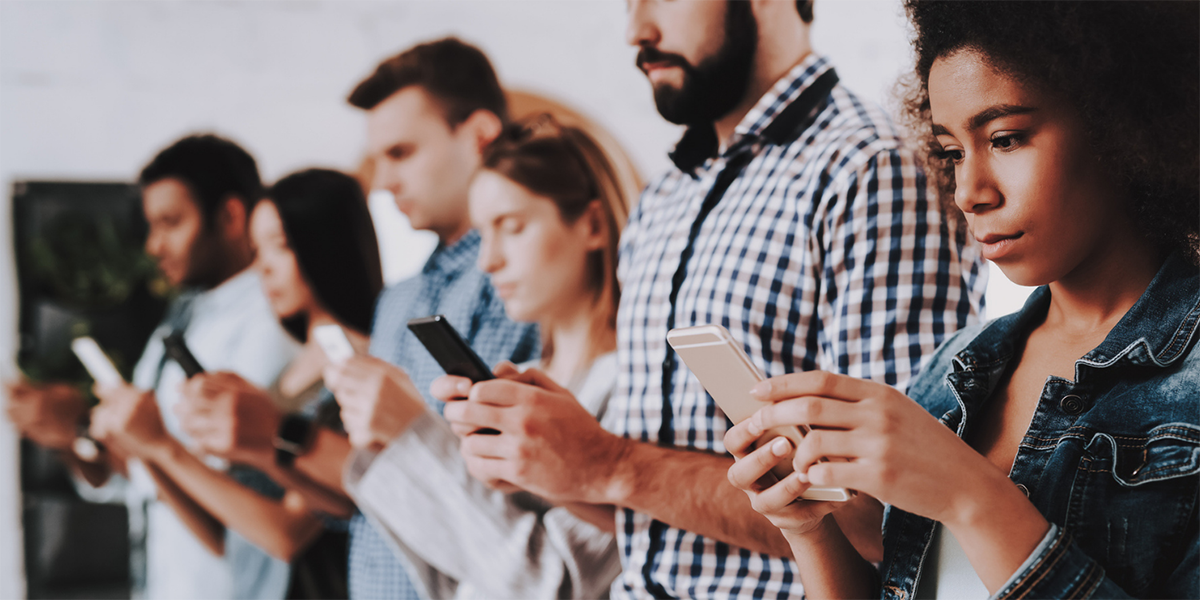 Several people looking at their smartphones