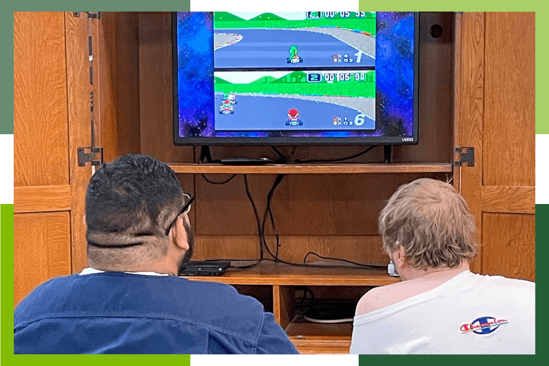 Two male Grand junction Regional Center residents battle in Mario Kart video game