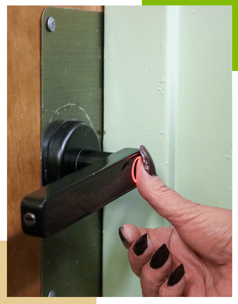 A female Pueblo Regional Center staff member uses her thumb print to unlock a door