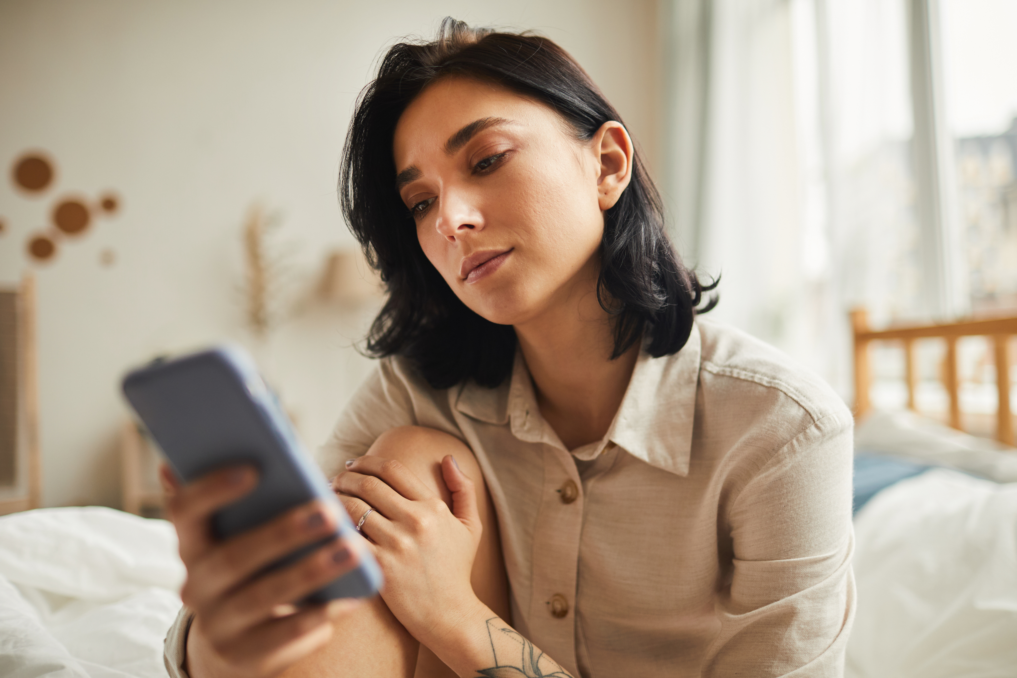 Woman looking down at her mobile phone.
