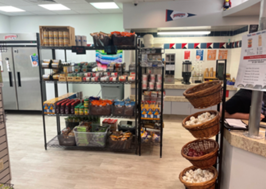 Shelves stocked with food at a corner store