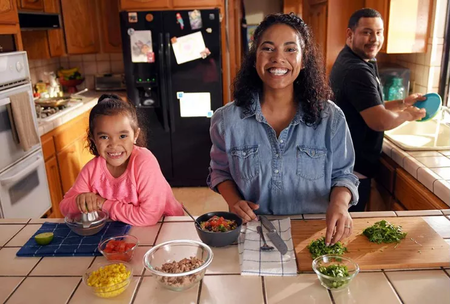 Family preparing meal together in kitchen