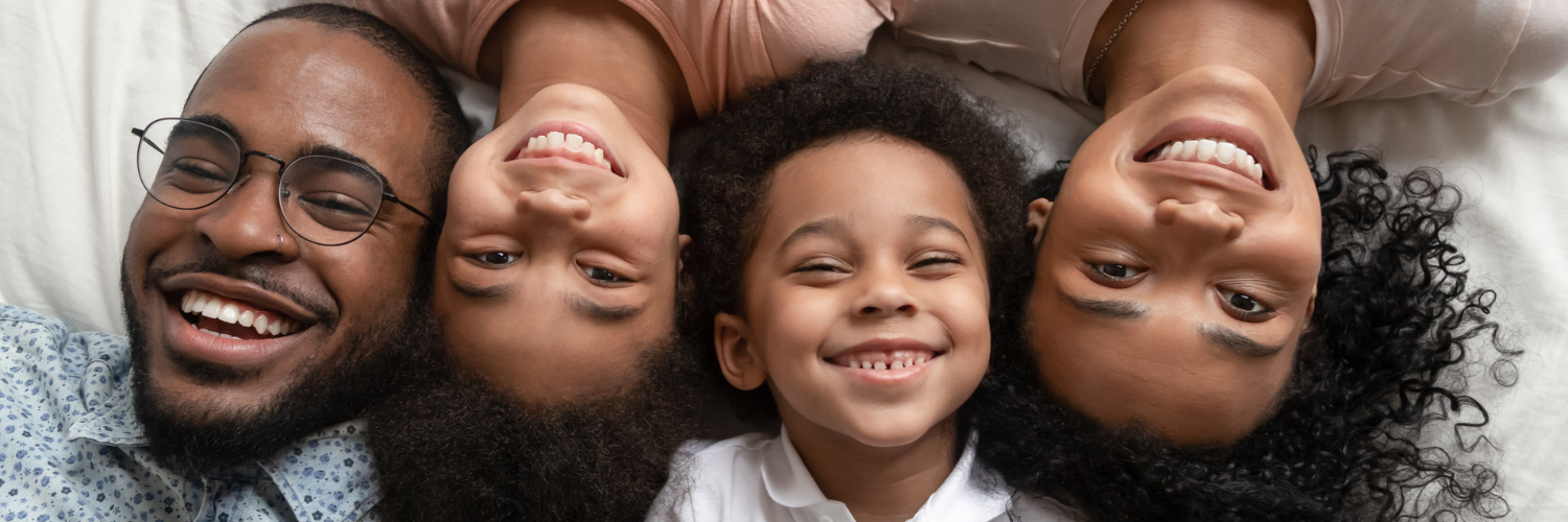 Mother, father and two children smiling at camera